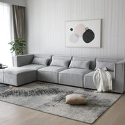 Sofá esquinero modular 4 plazas con puff gris Leila