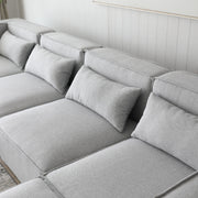 Sofá esquinero modular 4 plazas con puff gris Leila
